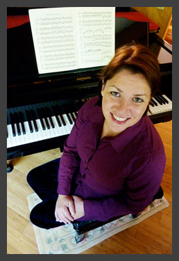 Carmen sitting at a piano